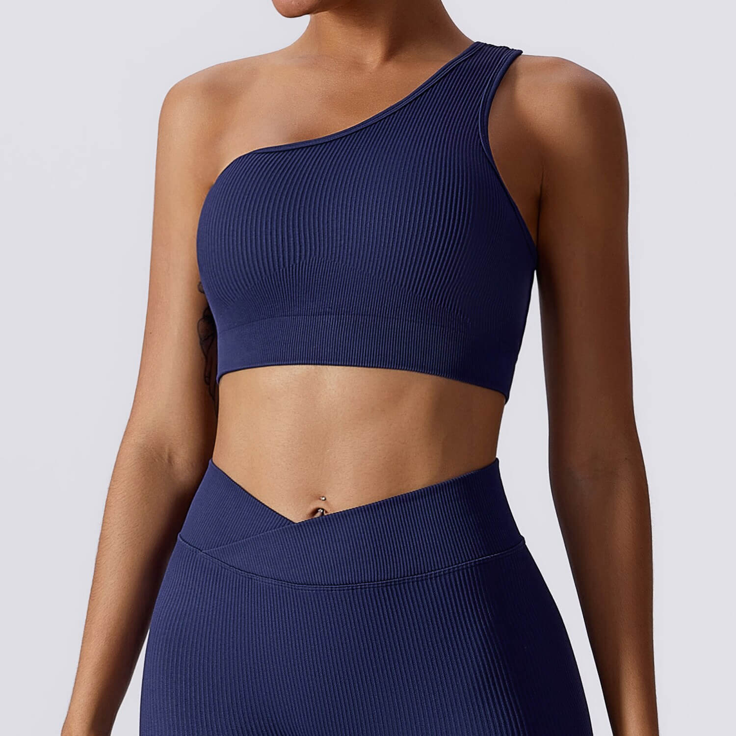 Women's one-shoulder sexy sports bra in blue, made of breathable nylon, perfect for fitness activities like running, cycling, and dancing.